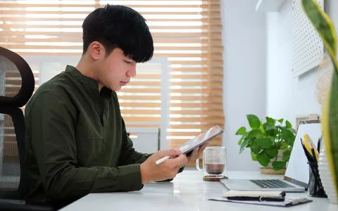 Side view young asian man working with laptop computer at comfortable workpla Foto stock