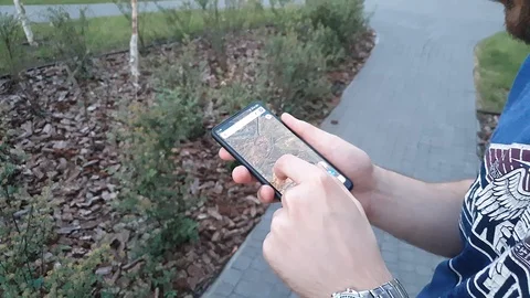 Side view of a young bearded man, using smartphone, mobile Internet Stock Footage 125902389