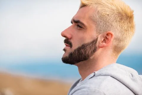 Side view of young bearded man blonde hair. Stock Photos