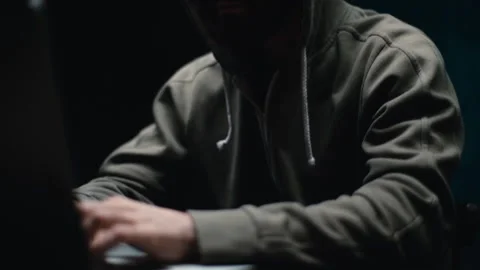 Side view of young bearded programmer hacking online site or password at desk in Video stock 145122642