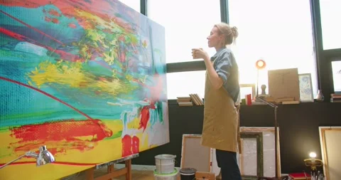 Side view of young beautiful Caucasian professional female painter in apron Stock Footage 149576866