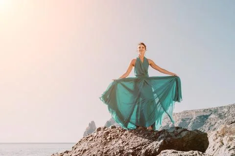 Side view a Young beautiful sensual woman with black hair in a long mint dress Stock Photos