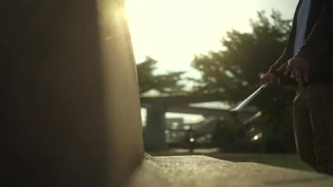 Side view of young blind man come to sit down on the bench against the beautiful Stock Footage 276485832