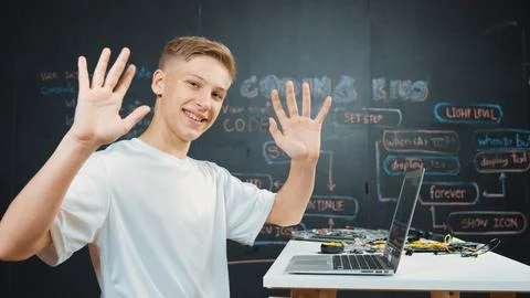 Side view of young boy programing code while looking at camera. Edification. Stockfoto's