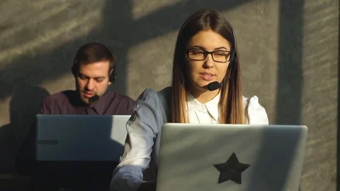 Side view of young call center agents at work Stock Footage 71008414