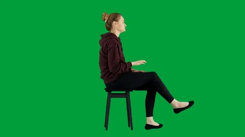 Side View of Young Casual Looking Woman Sitting on a Stool Waiting Green Screen Video stock 125161574