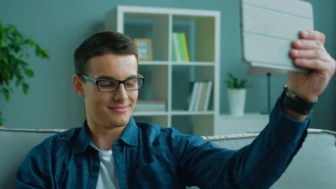 From side view young caucasian cheerful man in glasses with dark hair sitting on Stock Footage 77158123