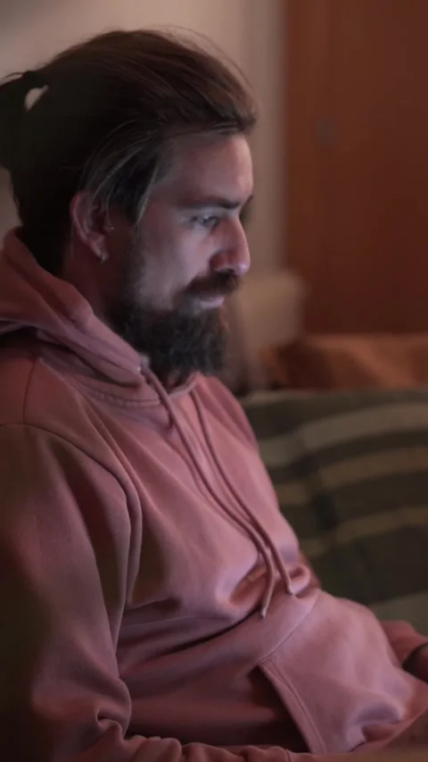 Side view of young Caucasian handsome man concentrating on laptop sitting on Stock Footage 275176053
