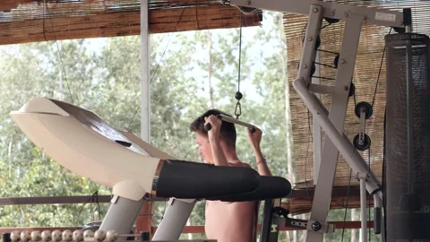 Side view of a young Caucasian man doing pull up exercise in the terrace at home Stock Footage 148245154
