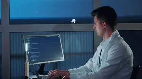 Side view of young electronics engineer being engaged in his research on Stock Photos