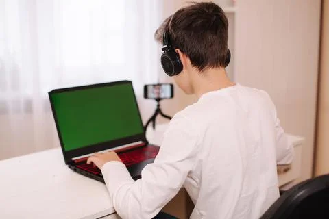 Side view of young ESportman playing game, capture video and broadcast screen 写真素材