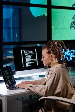 Side view of young female IT support manager with dreadlocks Stock Photos