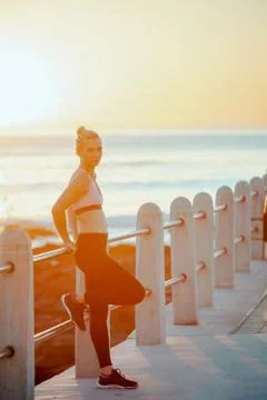 Side view of a young female post workout during a beautiful sunset Stock Photos