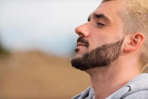 Side view of young handsome bearded man. Stock Photos