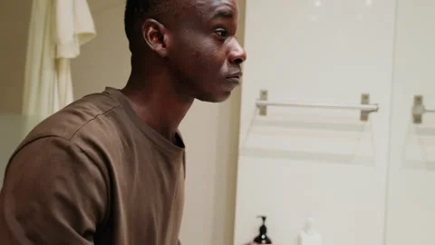 Side view of Young handsome Man Washing and Styling Hair in Bathroom Stock Footage 304820795