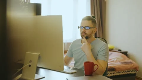 Side view of a young male working at home using a desktop computer. Stock-Footage 248004787