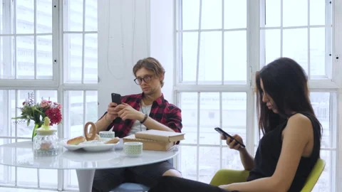 Side View A Young Man And A Young Woman Sitting On A Chair In A Bright Room Stock Footage 137093048