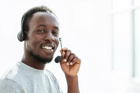 Side view. young man with headset talking into microphone Stock Photos
