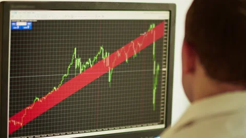 Side view of a young man sitting behind a computer monitor, stock trading Stock Footage 140125407