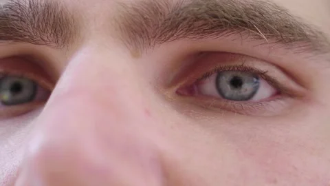 Side view of young man with stunning blue eyes opening Video stock 295141507