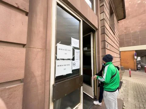 Side view of young man waiting in queue at polling station Bureau de Vote. 스톡 사진