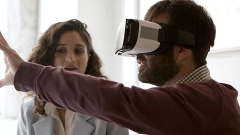 Side view of young man wearing virtual reality headset Stock Footage 121001096