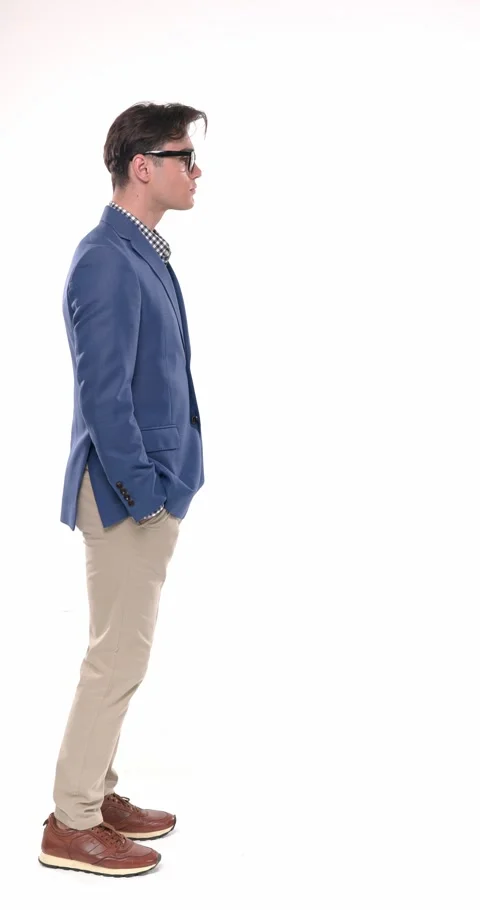 Side view of young man wearing blue jacket with glasses taking a step forward, Stock Footage 310043660