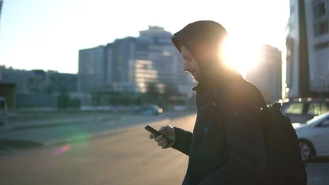 Side view of young men using smartphone at a street. Stock Footage 93335207