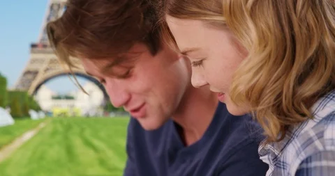Side view of young Paris couple using laptop outdoors Stock Footage 85805881