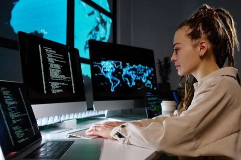Side view of young programmer developing new software or decoding data Stock Photos