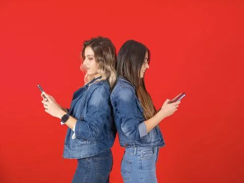 Side view young two caucasian women holding using mobile phones Stock Photos