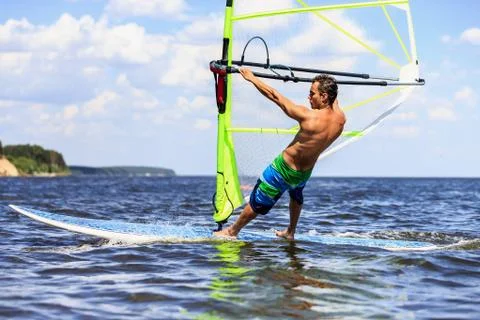 Side view of young windsurfer Stock Photos