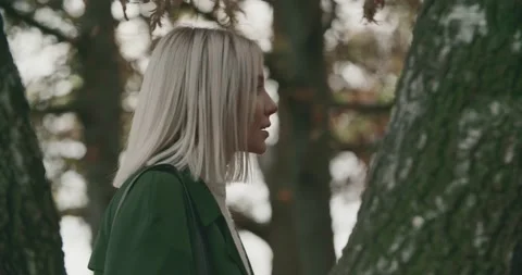 Side view of young woman exploring a forest far away from city in autumn. slow 動画素材 141132533