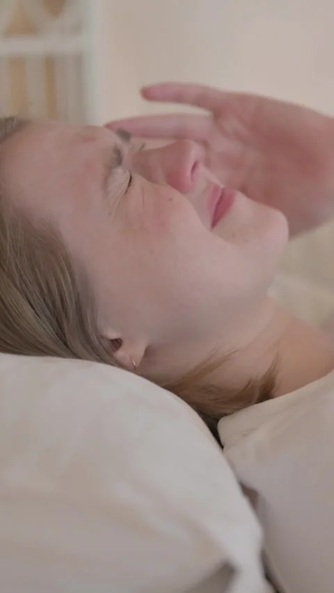 Side View of Young Woman with Headache Lying in Bed, vertical video Vídeo Stock 328564464