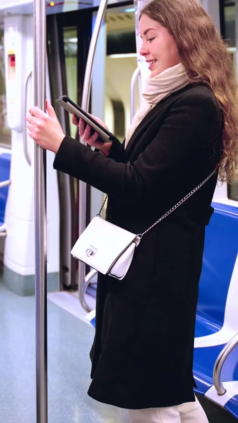Side view Young Woman Reading on E-Reader While Commuting on Subway.vertical Stock Footage 303572850