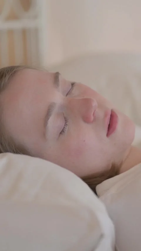 Side View of Young Woman Sleeping in Bed, vertical video Stock Footage 328564395
