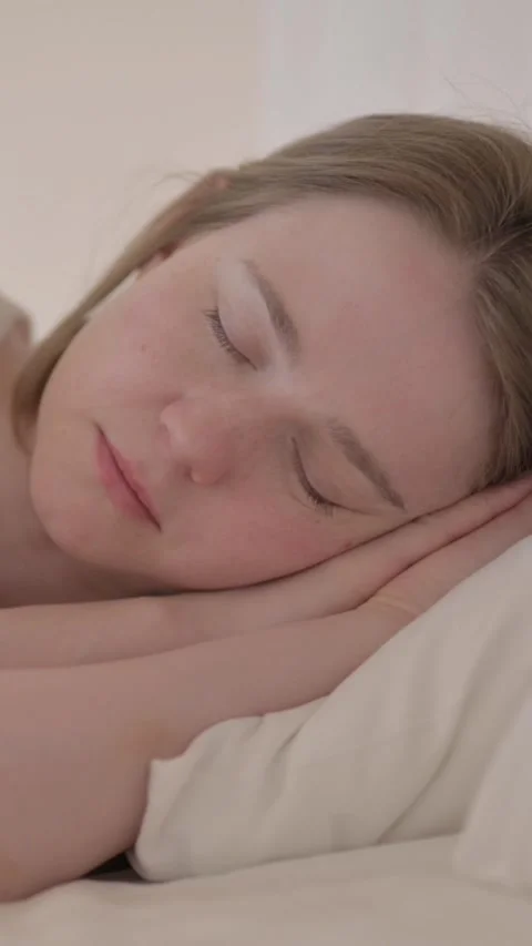 Side View of Young Woman Sleeping in Bed, vertical video Stock Footage 328564466