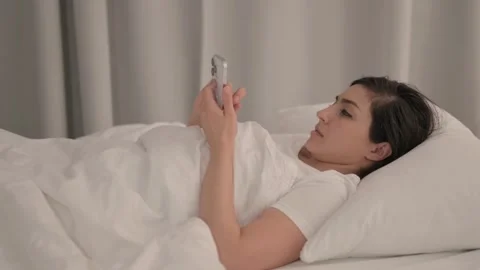 Side View of Young Woman using Smartphone in Bed 스톡 동영상 238650199
