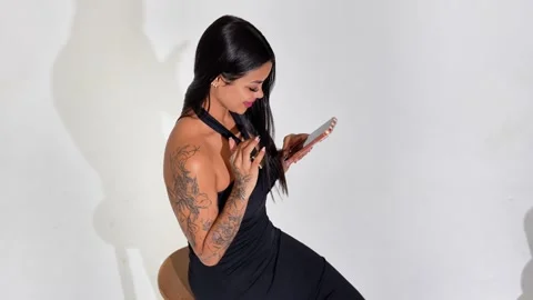 Side View of Young Woman Using Smartphone Against White Background Vídeos de archivo 333591272