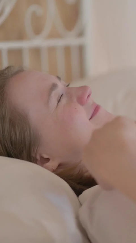 Side View of Young Woman Waking Up and Leaving Bed, vertical video Stock Footage 328564411