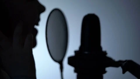 Side view zoom-out close-up shot of cute little girl silhouette singing with a Stock Footage 75196139