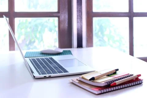 Side view,office table desk. workspace with notebook and mouse on copy space Stock Photos
