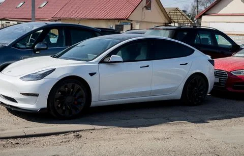 Side views of white Tesla Model 3 Stock Photos