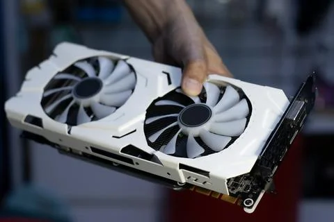 Side of white graphics card, computer parts, technician holding graphics card Stock Photos