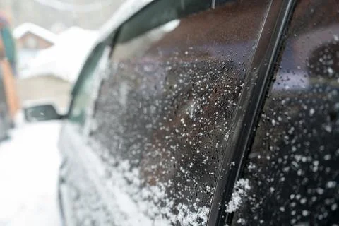 Side window of the car winter drops on the glass snow frozen green Stock Photos