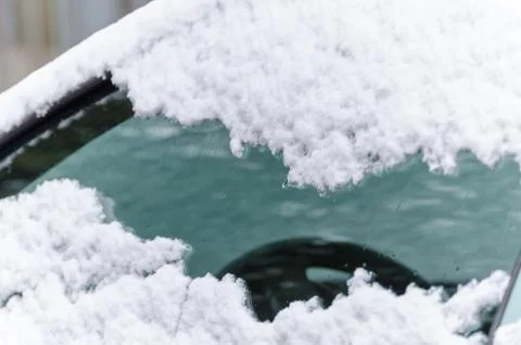 Side window of a car in winter with snow Stock Photos
