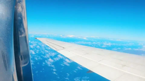 Side window view from airplane flying above the Atlantic ocean. Plane cruising o Stock Footage 273840448