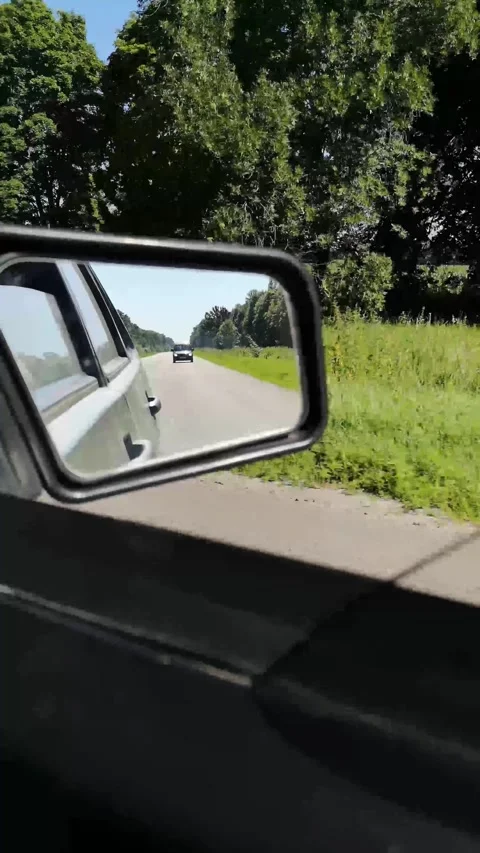 Side window view of a moving car showcasing summer landscapes Stock Footage 296270675