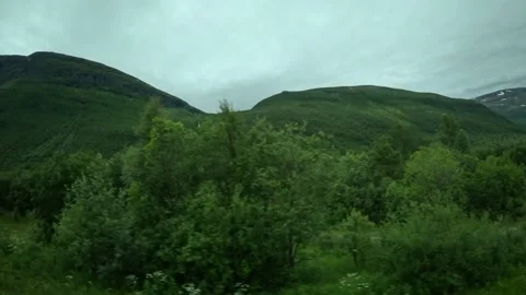 Side window view of traditional red barn with caravan and mountains in Norway Stock Footage 341272662