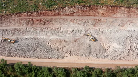 Sidehill cut on the road construction route or quarry. Removing rock and soil Stock Footage 156707903